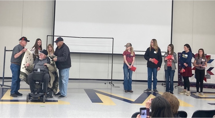 Cody Middle School Scholars presenting their Quilts of Valor.