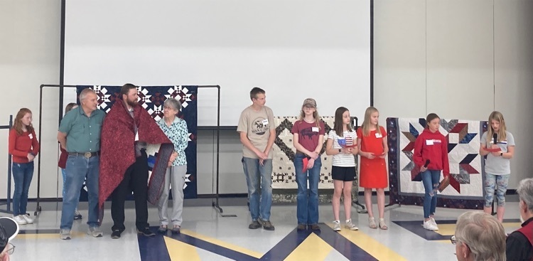 Cody Middle School Scholars presenting their Quilts of Valor. 